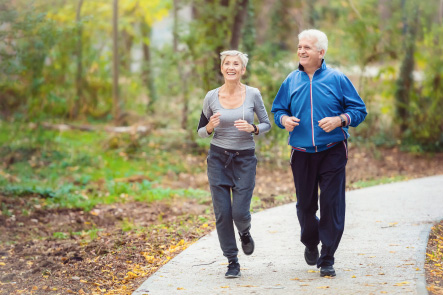 A Happy and active elderly couple out for a jog