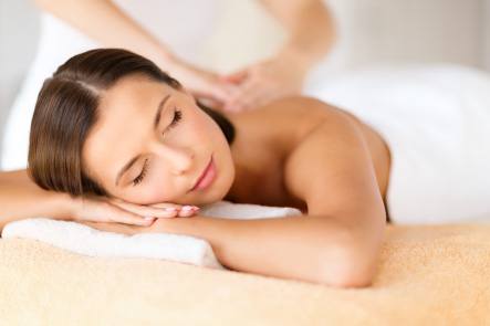Young woman relaxing while a registered massage therapists massages her back